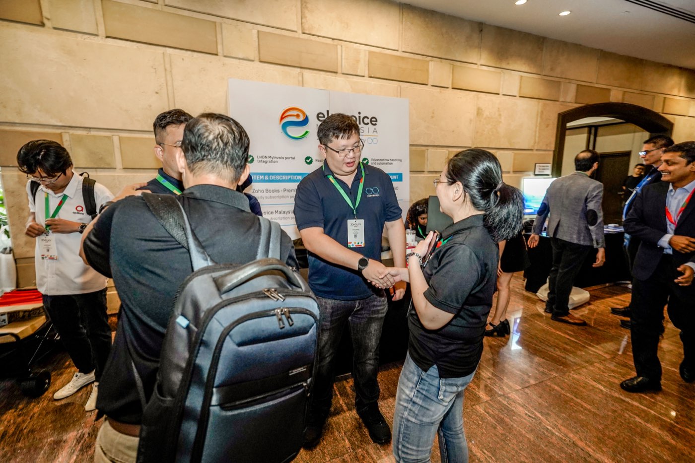A handshake at the Ooroboros booth, Zoholics APAC