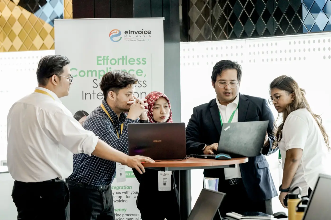 The Ooroboros team working through the e-Invoice plugin at the Zoholics APAC booth
