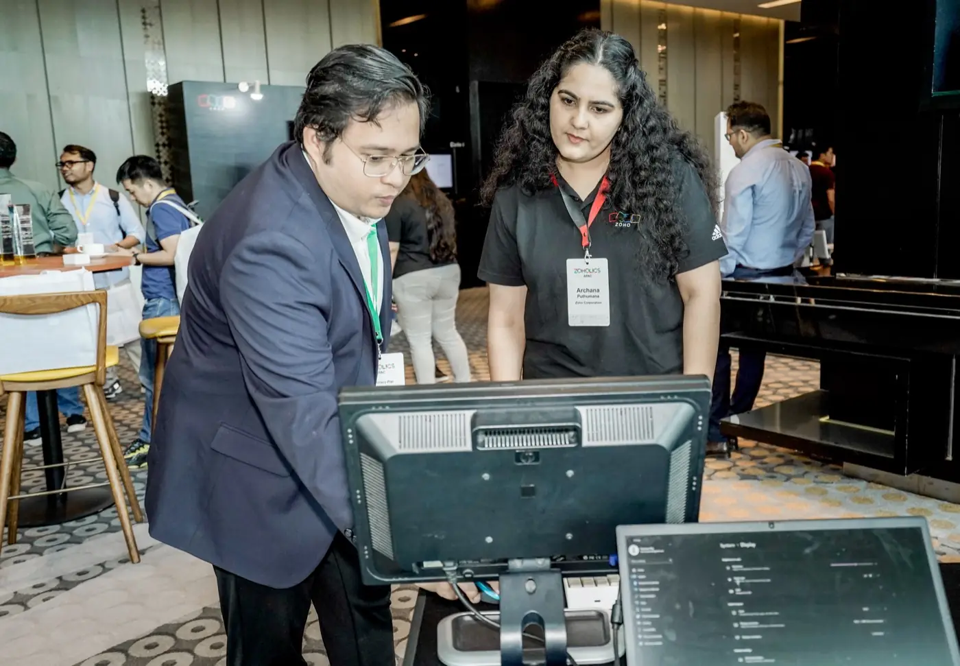 Francisco reviewing the work with a Zoho Corporation colleague at Zoholics APAC